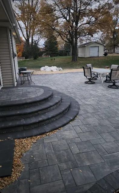 Paved patio with circular steps and backyard view in Twin Cities
