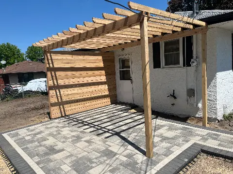Wooden pergola over paver patio at residential home in Minnesota