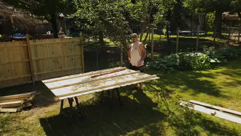 Landscaping work in progress with wooden boards in backyard