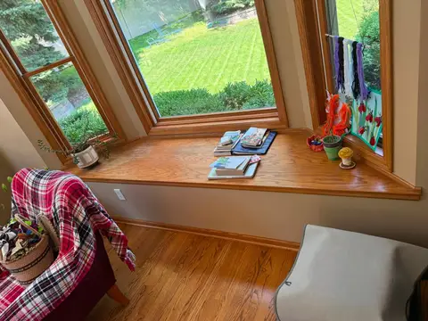 Cozy window seat with books and decor in well-lit room